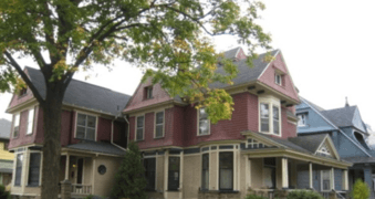 a large house with a large tree in front of it